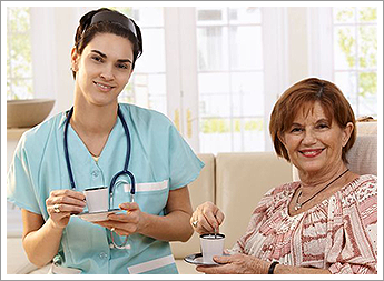 Nurse and Senior Patient Having Tea